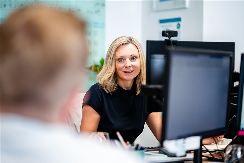 Woman in an office talking to a colleague
