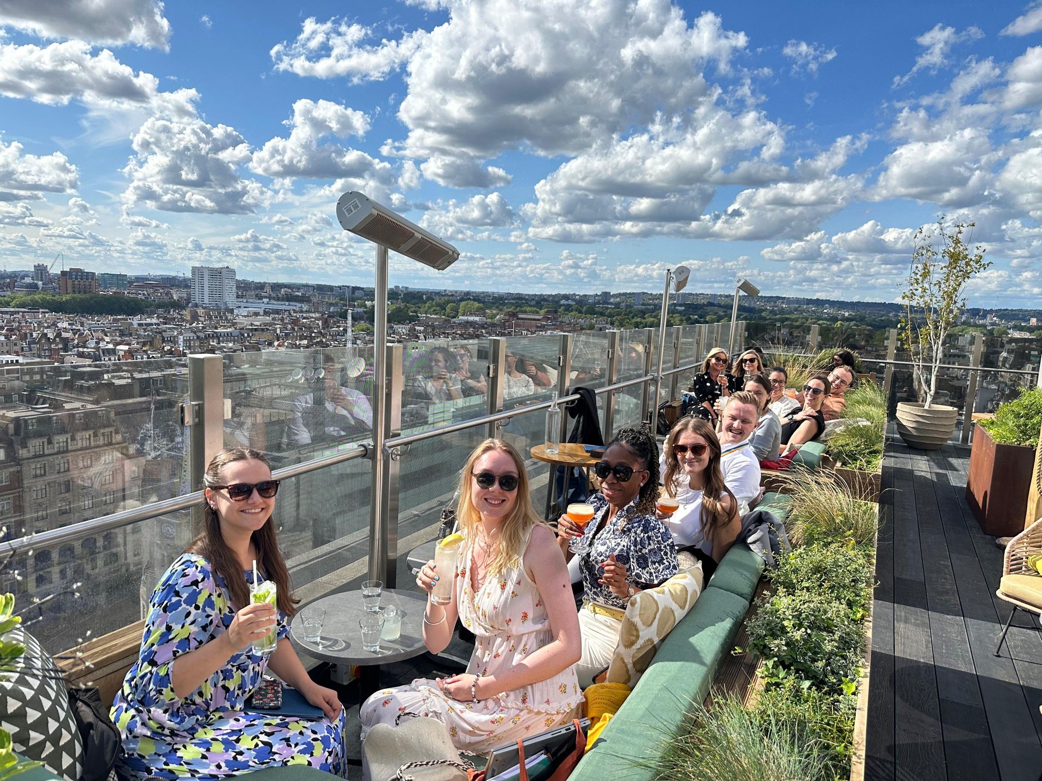 Group having drinks on a roof terrace in summer